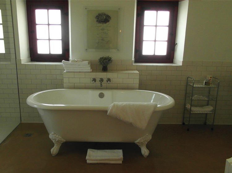 Babylonstoren Bathroom with free-standing bath with simple yet luxurious features.