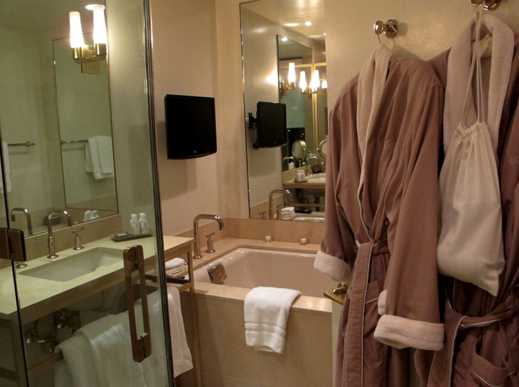 Sunset Tower A bathroom fit for Marylin. Monogrammed robes, a TV in the candle-lined tub, and Kiehl's amenities. 