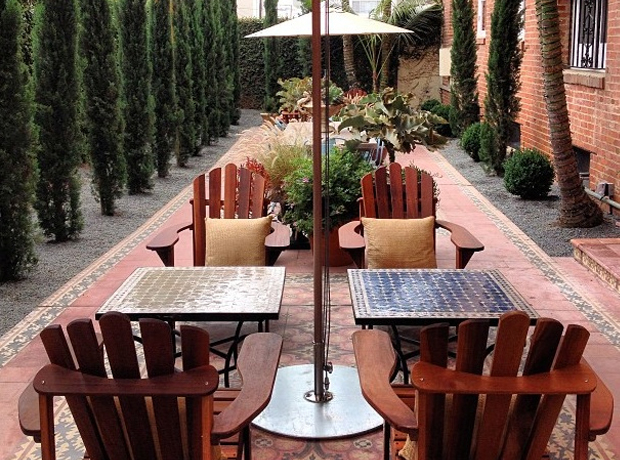 Palihouse Lovely garden terrace with Malibu tiles and Cyprus trees. 