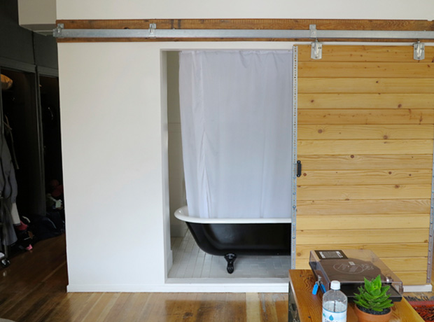 Ace Hotel Portland Sliding barn door shows off the old-timey tub & leaves the whole room feeling warm, open, and friendly. 