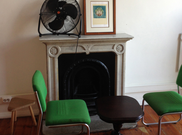 Hostel Independente In my room was this cozy niche near the fireplace, complete with vintage furniture and an industrial-scale fan for the warm nights. 