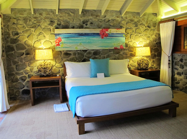 Petit St. Vincent Simple luxury at its best. The painting above the bed is by an artist who was commissioned to create works that reflected the vibrant colors and lush environment of the island. 