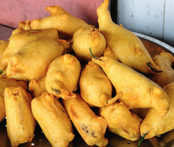 A spicy pepper, deep fried in chickpea flour and potato. Wash it down with a cool mango lassi.