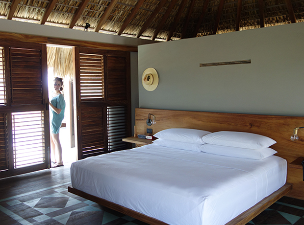 Hotel Escondido Inside of our bungalow. Super comfy bed. Note the flashlight, portable Bose bluetooth speaker and deco analog alarm clock on the bedside table. Also note the sombrero. Wear the sombrero.