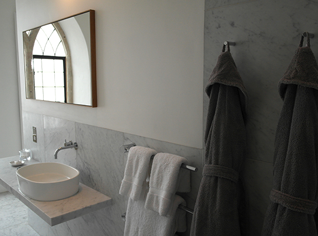 At The Chapel Beautiful grey and white marble bathroom with huge tub and walk-in shower.