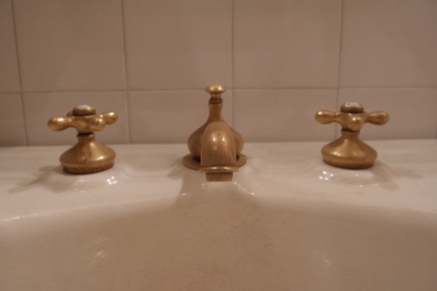 Lafayette House The bathroom’s original brass fittings