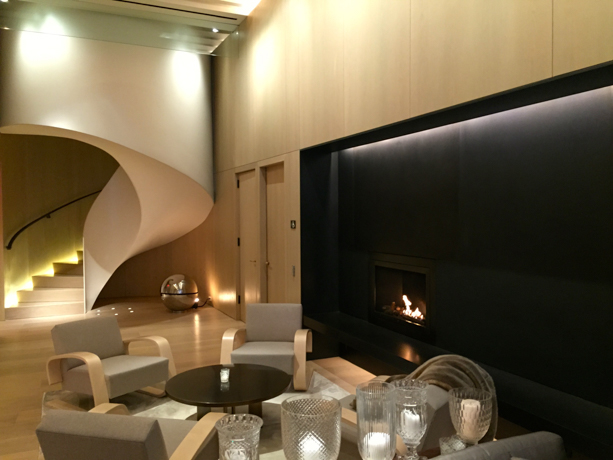 The New York Edition Back downstairs, a hand-forged steel fireplace stretches the length of the backwall of the lobby.
