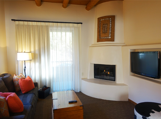Enchantment Resort Casita Junior Suite living room, complete with beehive fireplace, a small outdoor patio and charming Southwest flair.  