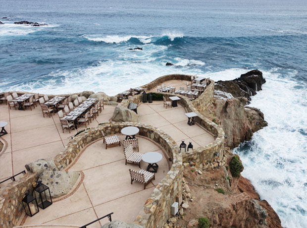 Esperanza Everywhere on the property, the natural landscape is the star, like this dramatic outdoor dining area that follows the curve of the seaside cliffs. 