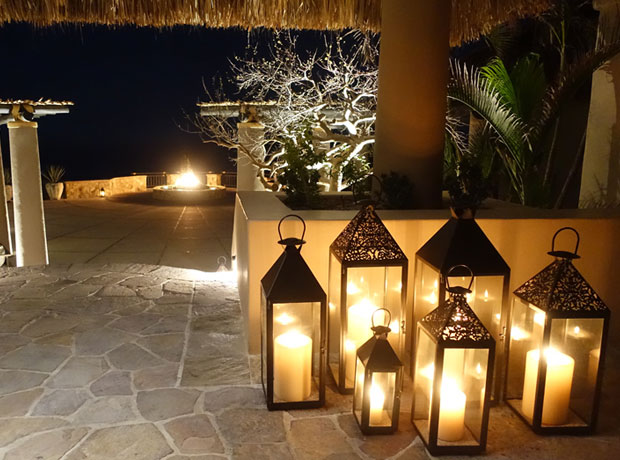 Esperanza Lanterns set a mellow mood throughout the property at night, and blowing out the lanterns on your own terrace becomes a welcome nighttime ritual. The fire feature in the background was designed as a modern interpretation of a beach bonfire. 