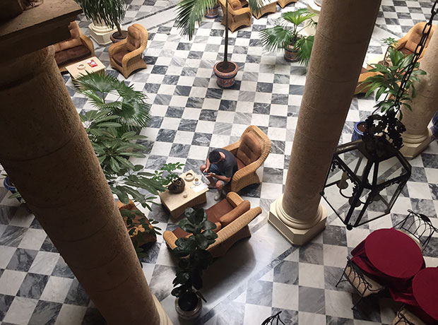 Hotel Florida Mr Richard Danks working from the elegant lobby. The chequered marble was almost pornographic.