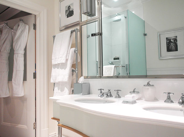 The Connaught Sleek, large bathroom with black & white photos of Hollywood stars.