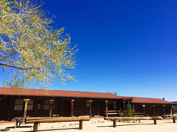 Pioneertown Motel Front view of the traditional roadside motel. Drive right up to your room. There are picnic tables and seats to chill outside, make friends and stargaze at night. 