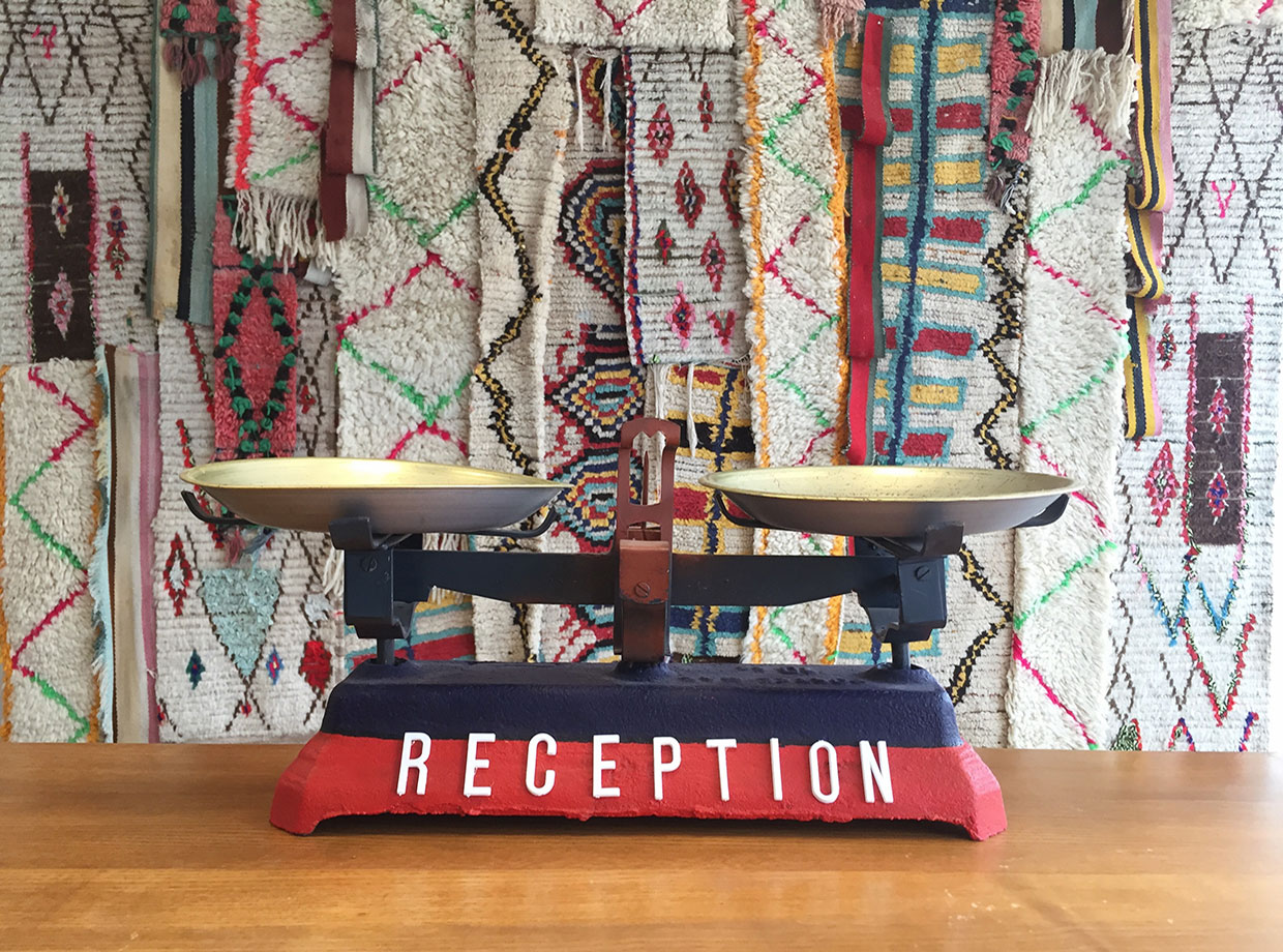 Amouage Funky reception desk with Berber rug installation in the background.