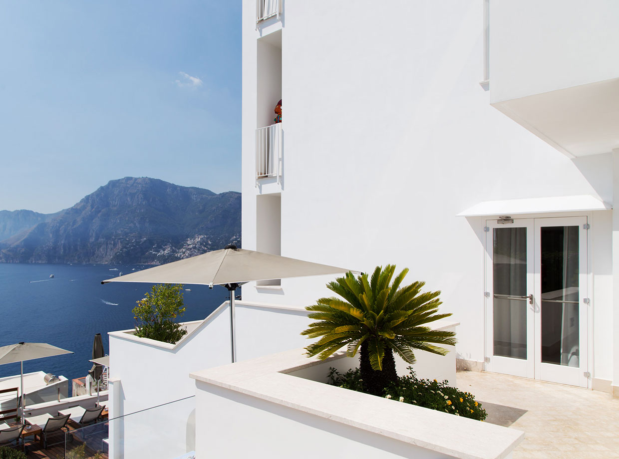 Casa Angelina One of the many palm lined terraces and the view of Positano.