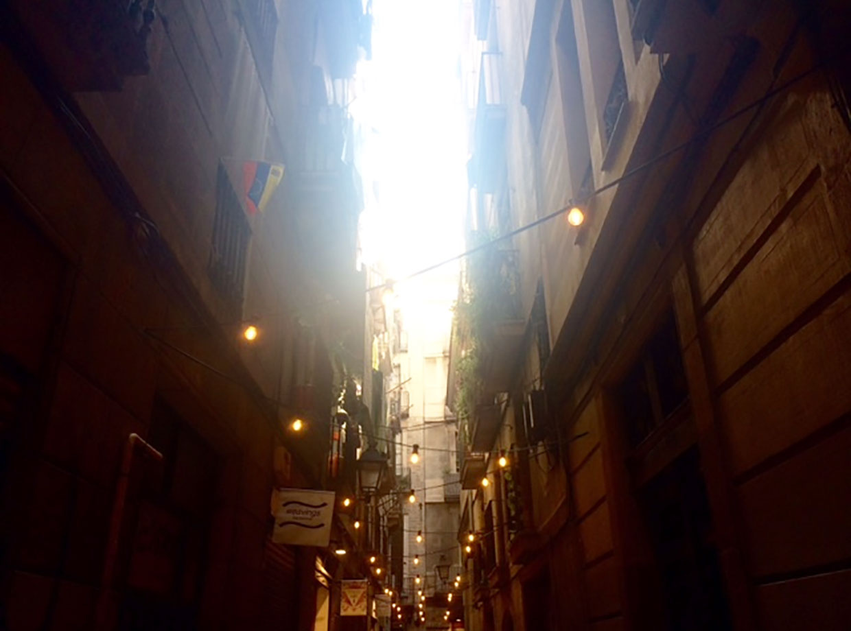 El Palauet Living Barcelona Charming alleys lit with market lights in the Gothic Quarter.