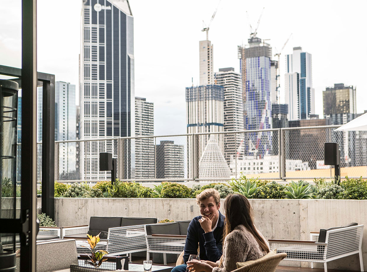 QT Melbourne Rooftop bar with killer city views. The split indoor-outdoor space on the 11th floor of the hotel can hold 185 people. Furniture is by Melbourne designers, Tait.