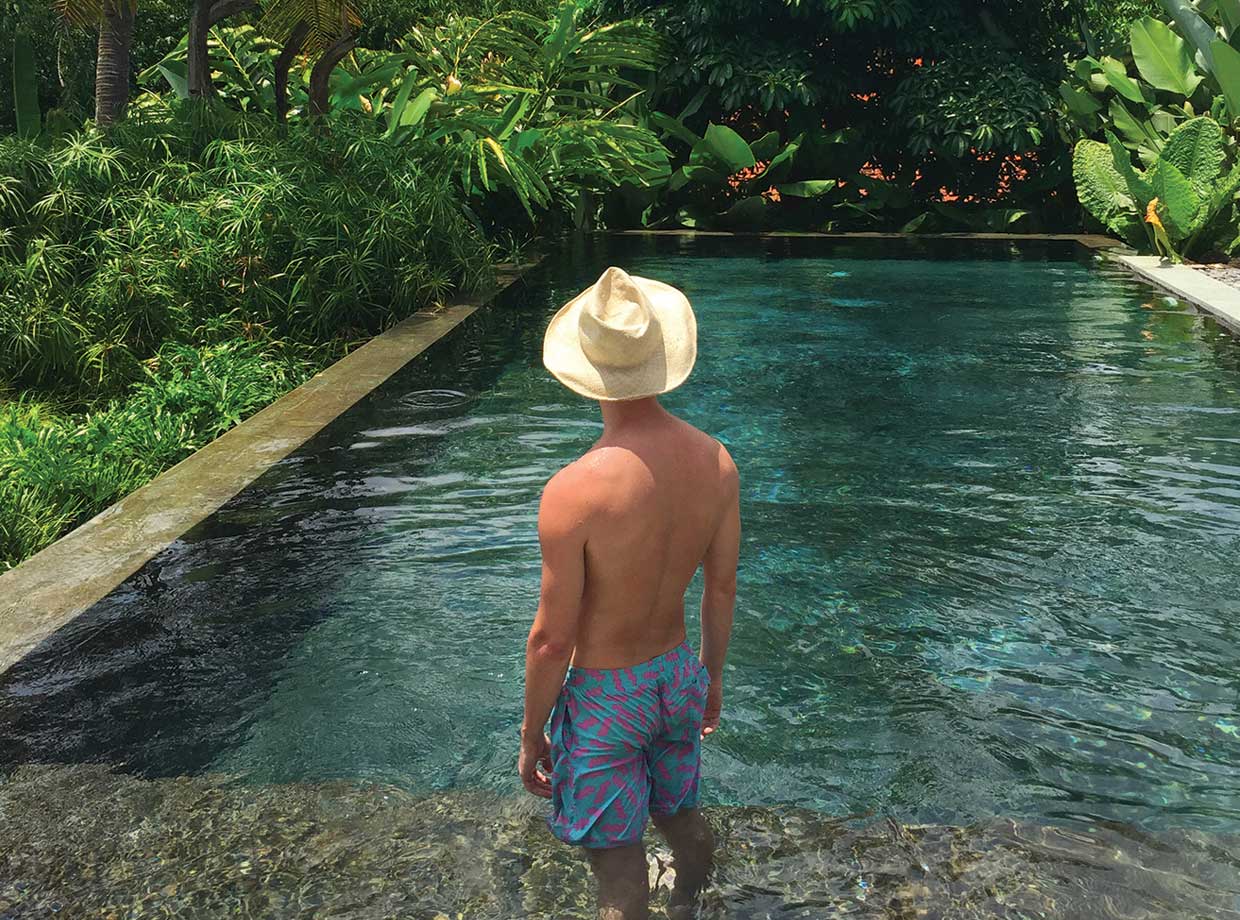 Kalapa Resort and Spa At the pool sporting one of the traditional Balinese straw hats found in the wardrobe.