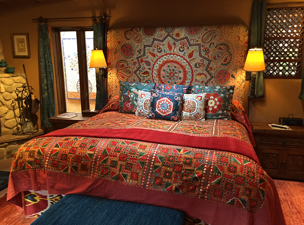 The Inn of Five Graces The huge bed with colourful Tibetan furnishings. 