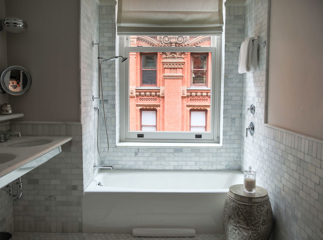 Beekman Hotel A luxurious Carrara-marble tiled bathroom perfect for afternoon soaks.