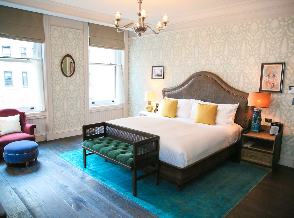 Beekman Hotel ...Eclectic block-colored décor with items like pillows, table lamps and ottomans that accent the bedroom.