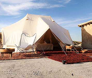 Spend an evening riding camels and dining in a candlelit Berber tent at this very chic off-the-grid desert camp.