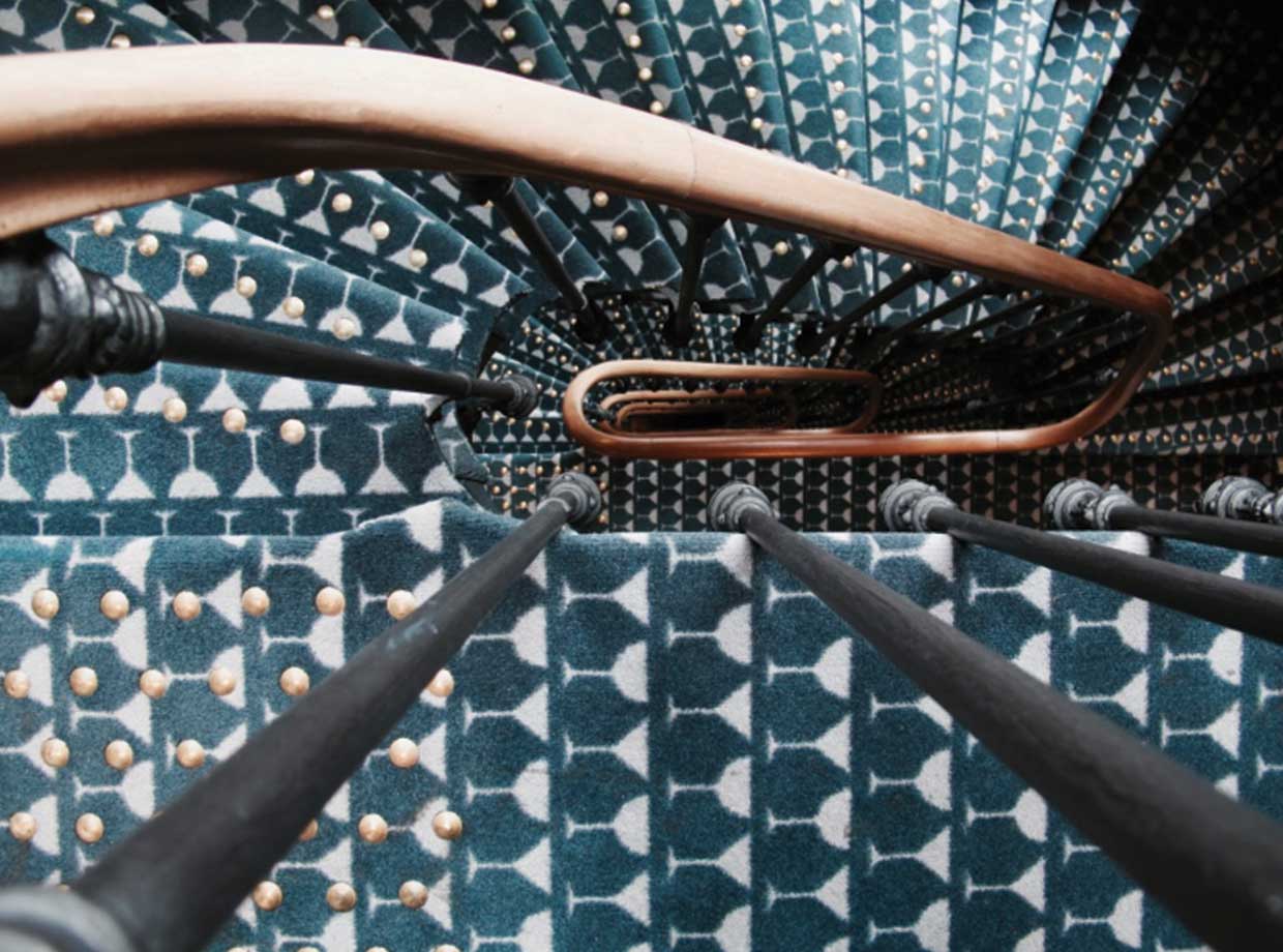 Le Grand Pigalle Hotel The iconic staircase with custom made martini rug designed by Dorothee Meilichzon (don’t worry, there’s an elevator too).
