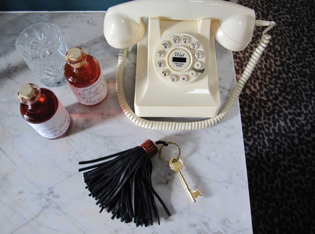 Le Grand Pigalle Hotel o much YES in this picture. The telephone (that you can buy and take with you btw), the leather key tassel, the house mixed cocktails with hand written labels (double yes) and the leopard rug??? I need to lay down on that bed again. 
