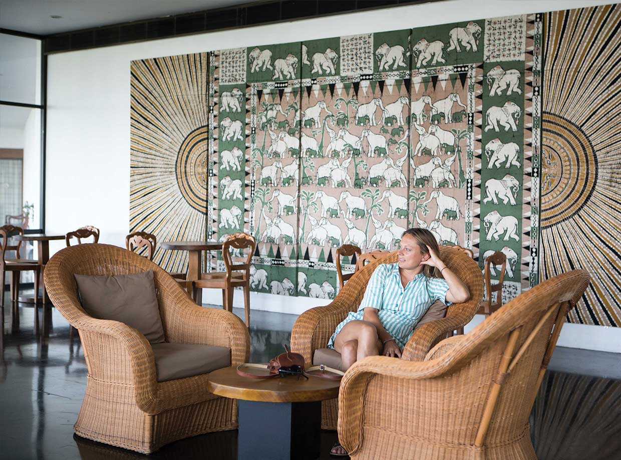 Heritance Kandalama Me enjoying the Geoffrey Bawa-designed furniture with Sri Lankan batik artwork on the wall behind. 