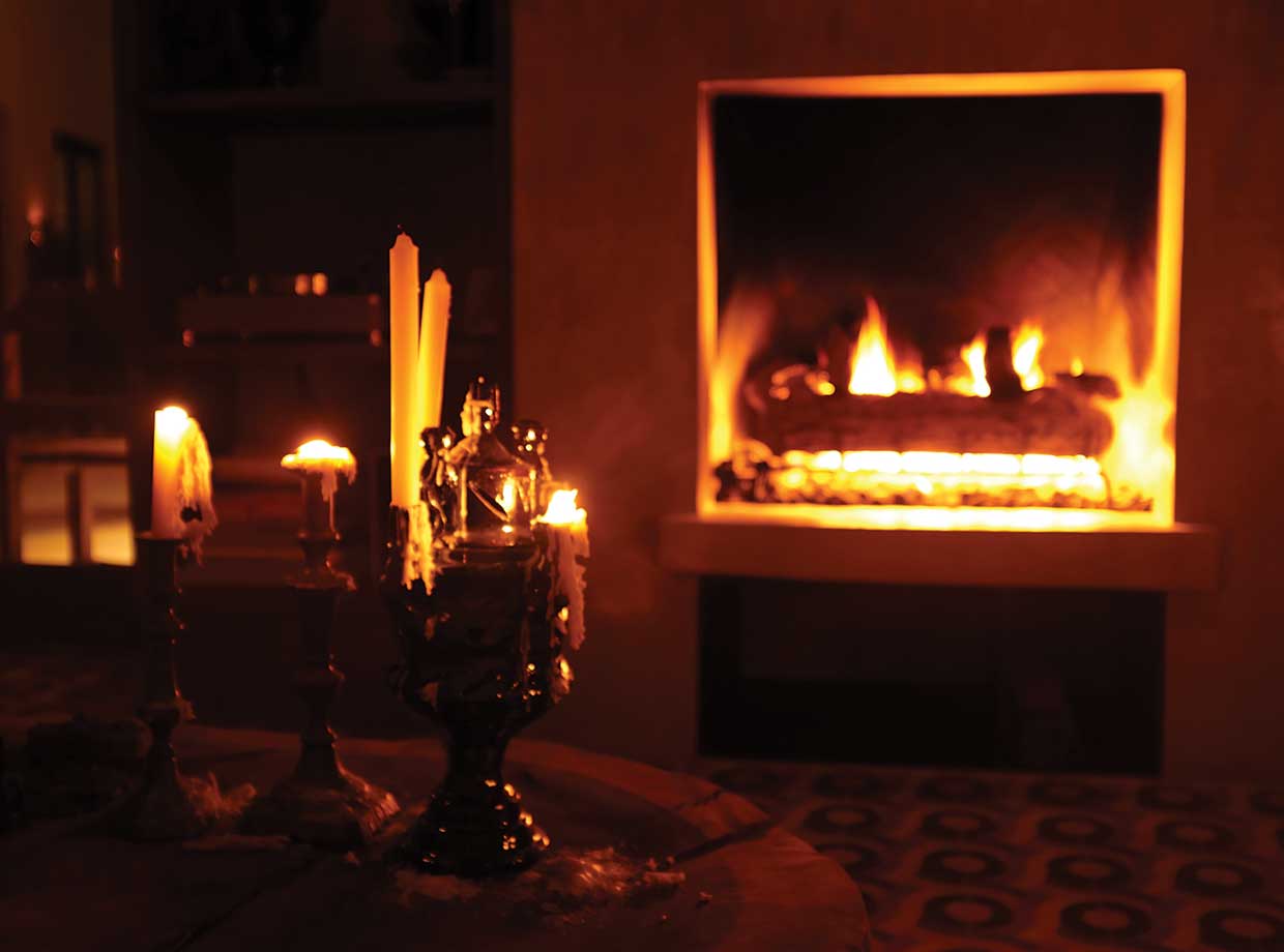 Hotel San Cristobal Cozy up in the communal room with this fireplace, record players, and candles.