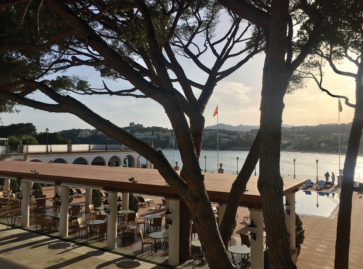 Hostal de la Gavina Poolside Garbi restaurant during golden hour.