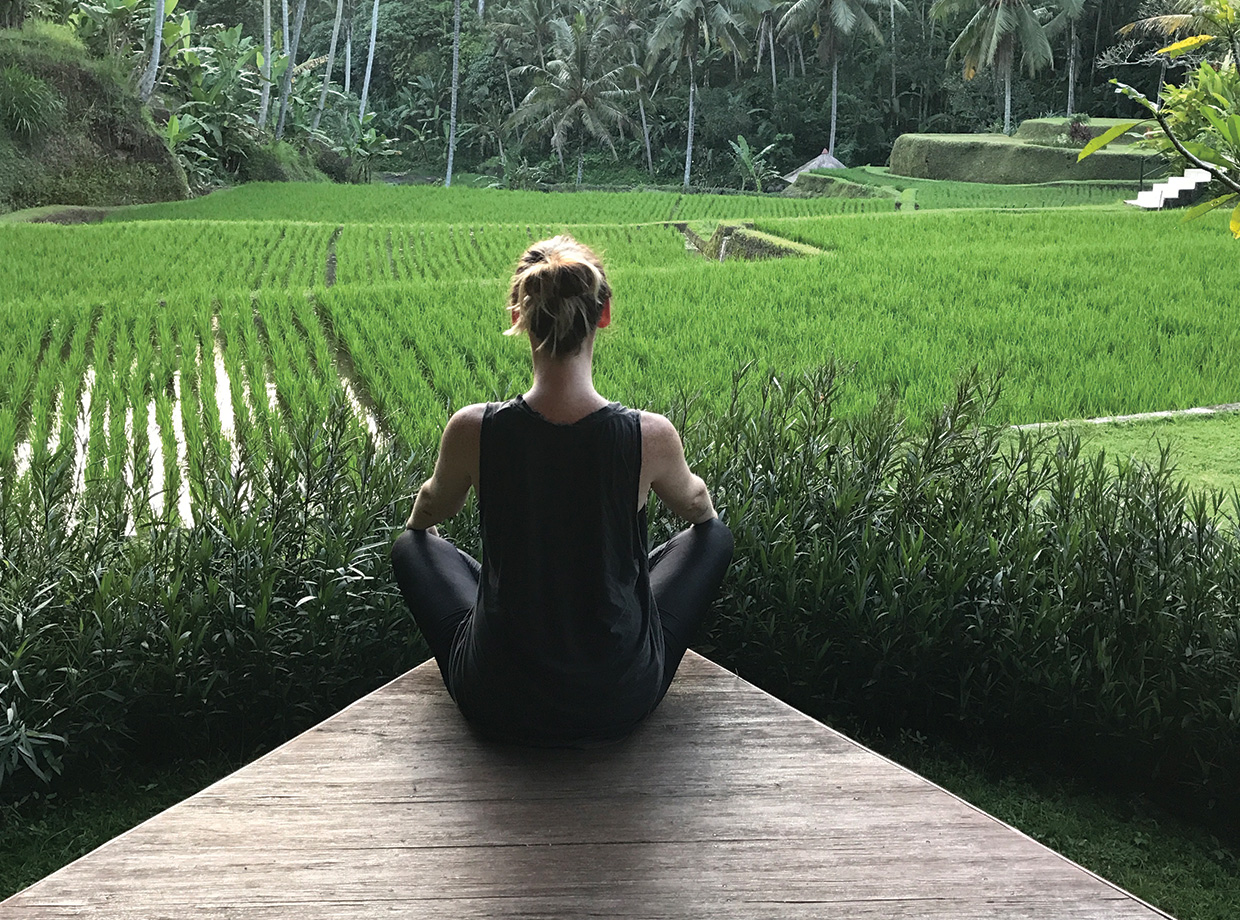 Four Seasons Resort Bali at Sayan Me doing sunset yoga looking over the hotel’s adjoining rice fields.