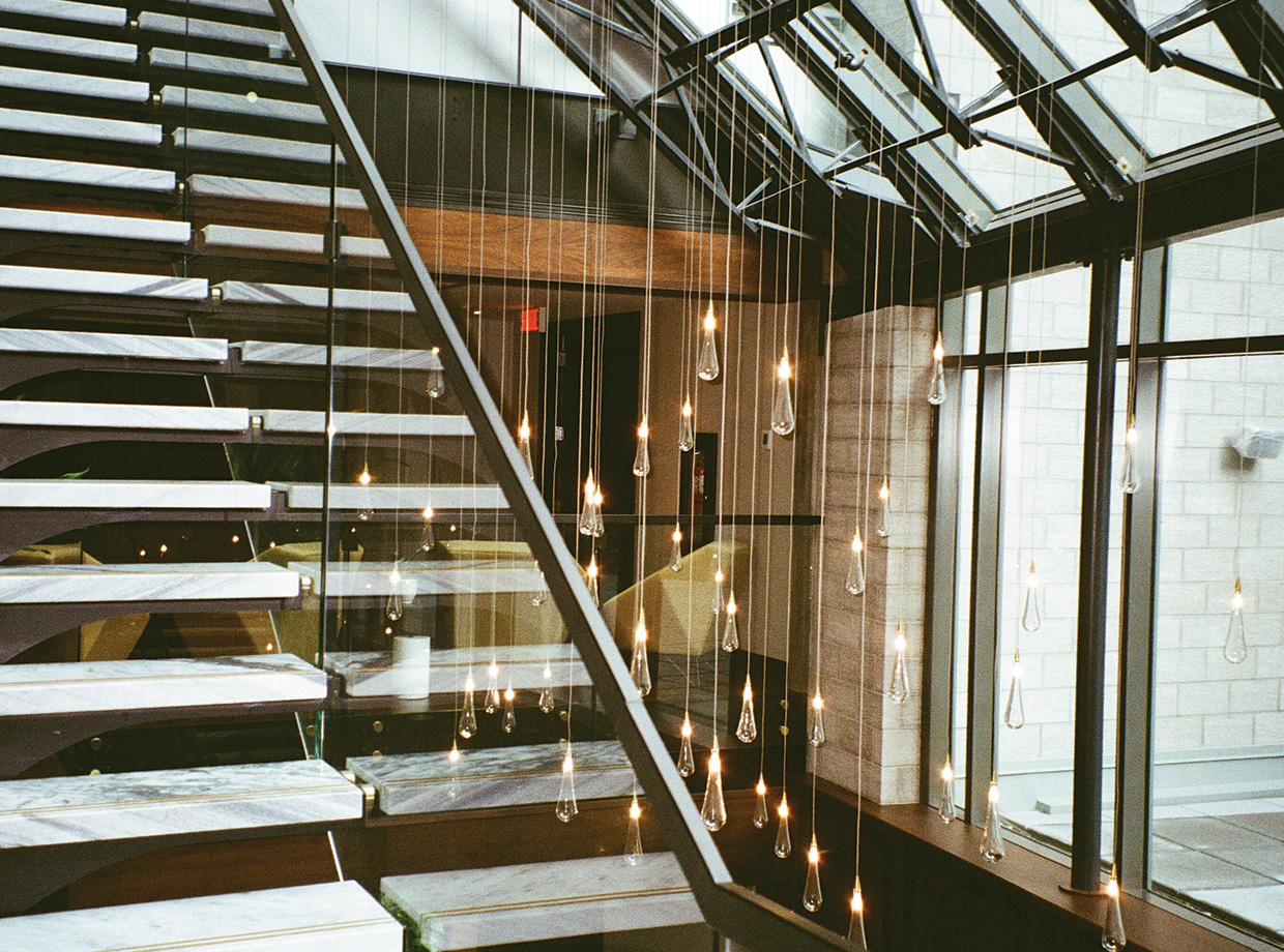 Hotel William Gray Hanging lights illuminate the marble ascent to the hotel’s event space.