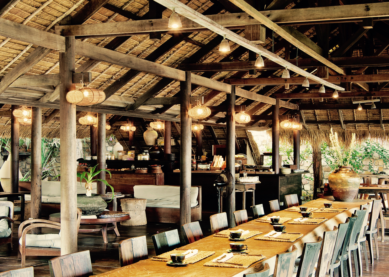 Knai Bang Chatt Rustic wood tables and cosy seating areas are the perfect place to enjoy beautiful buffet breakfasts, or a seaside candlelit dinner served here at The Strand.