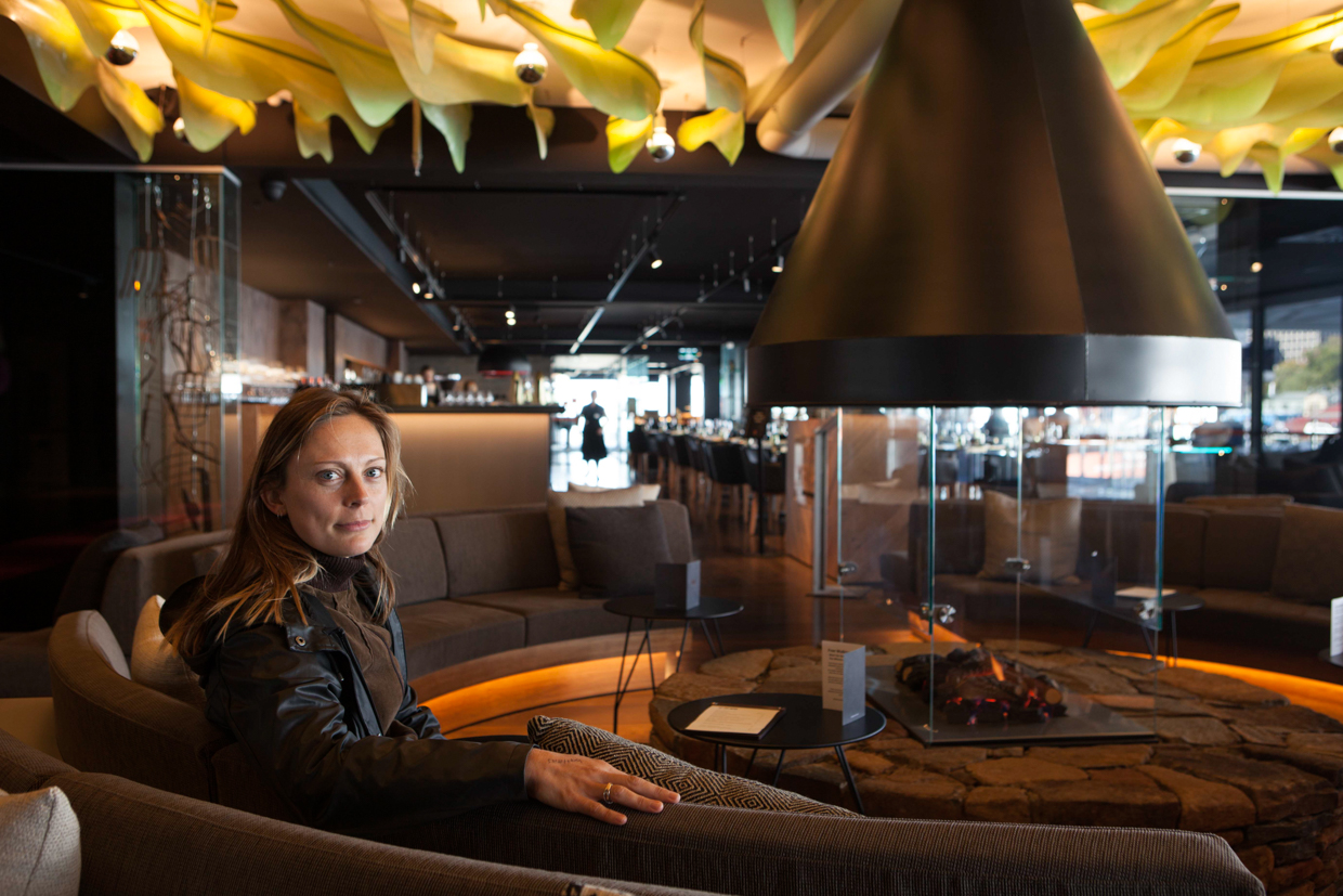 Macq01 Sitting in the lobby next to the central fireplace, under an impressive yellow wave-like roof installation. 