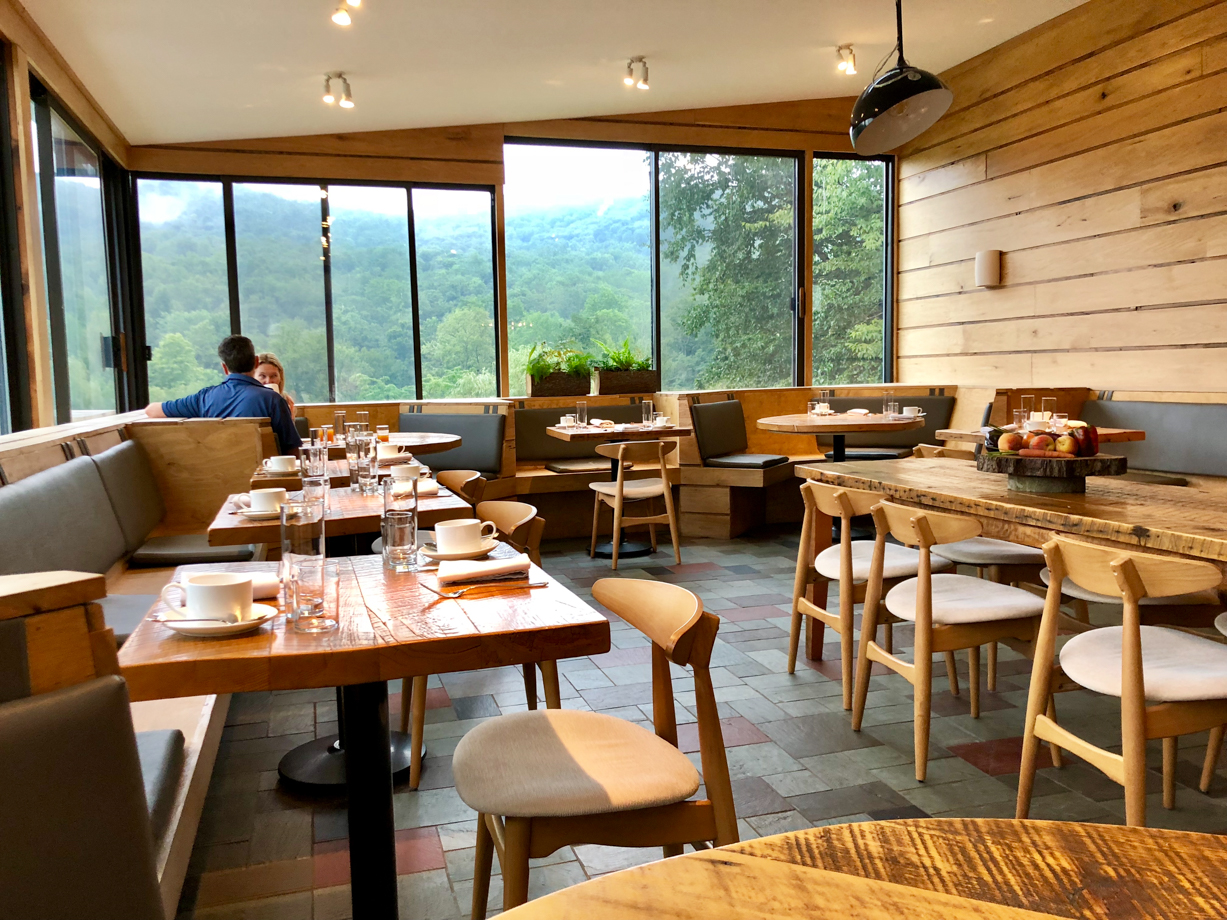 The DeBruce The glass walled dining room overlooking the beautiful view.