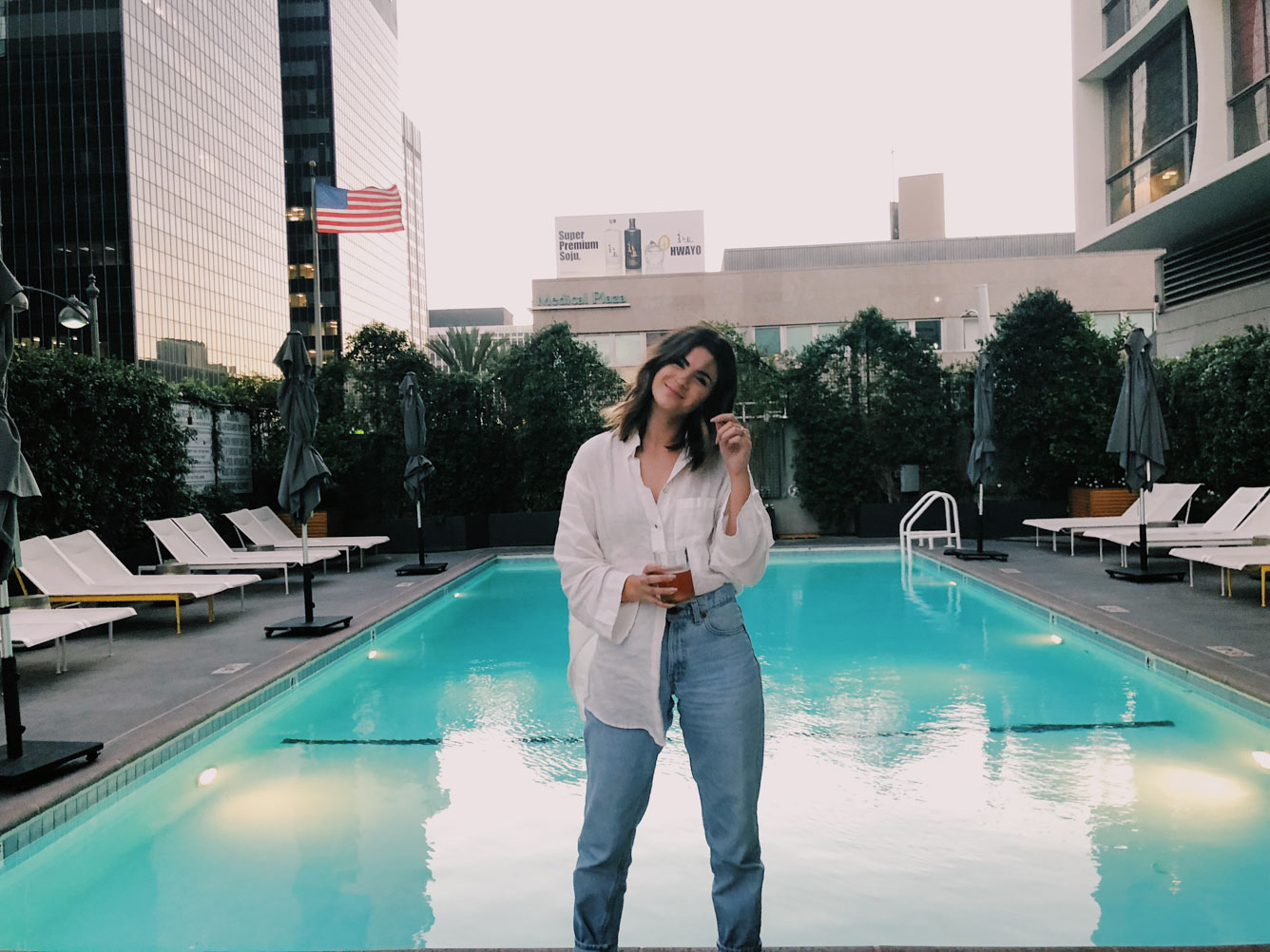 The LINE LA Living the dream with drink in hand at the rooftop pool.
