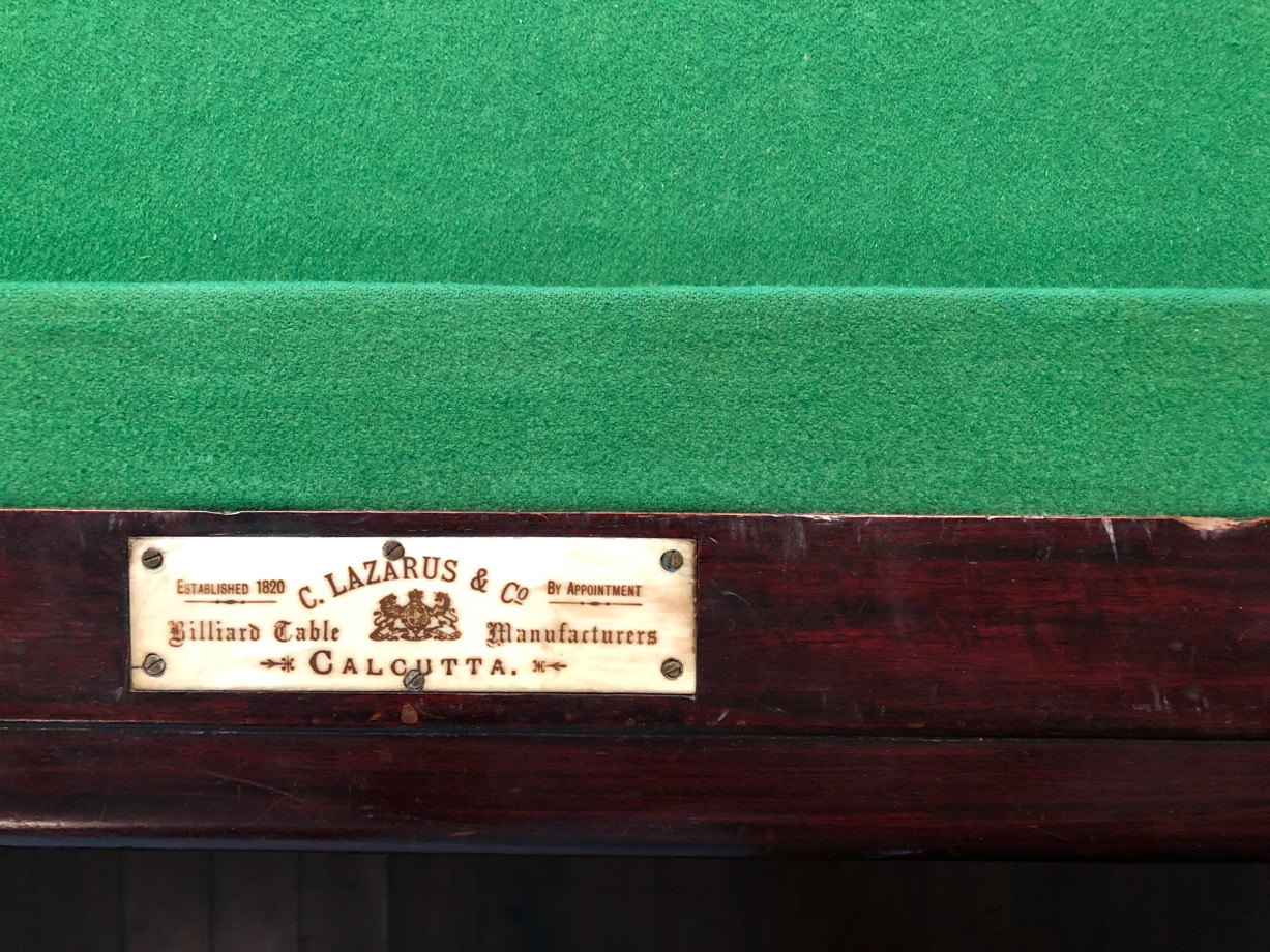 Ananda Play a game of pool on an antique billiards table.
