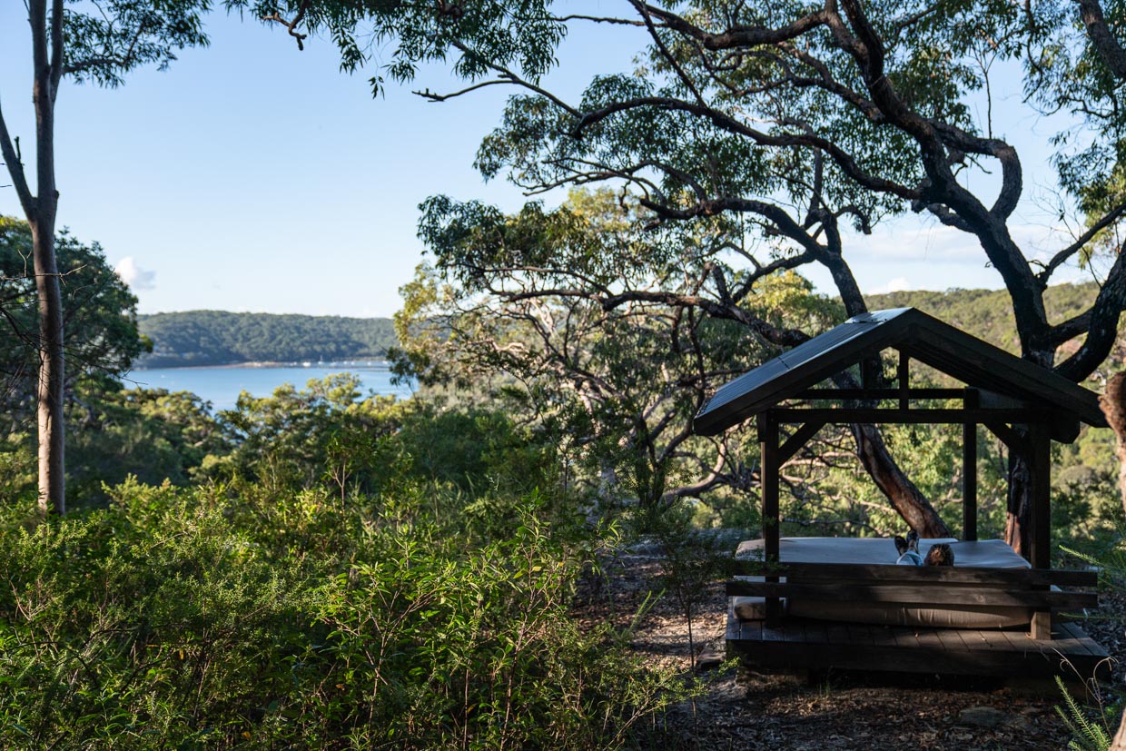 Pretty Beach House Wander down a path on the property to find this day bed over look Pretty Beach and the national park. You could spend hours here reading a book. 
