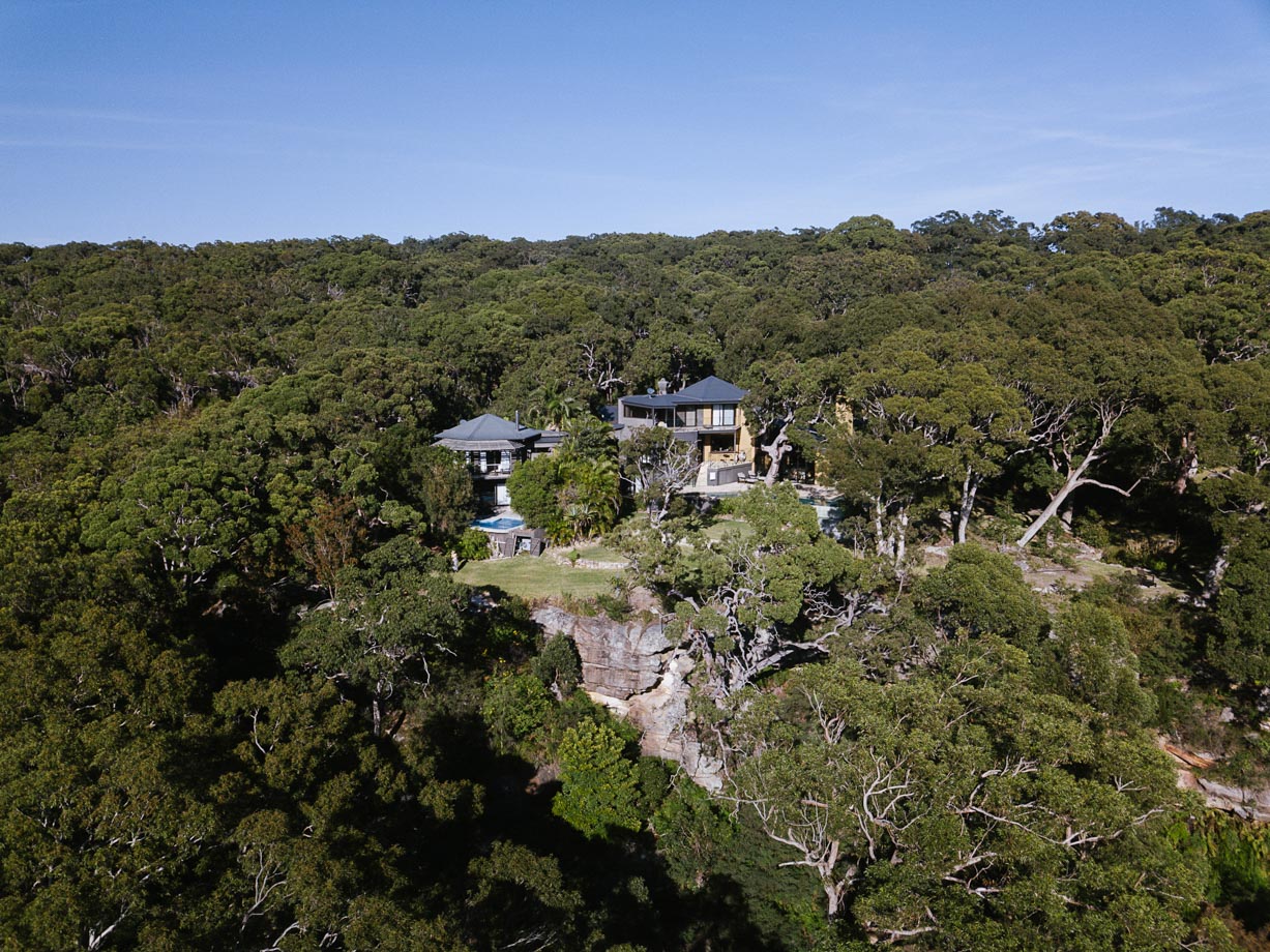 Pretty Beach House Pretty Beach House from the sky, tucked into the trees high on the hilltop. 