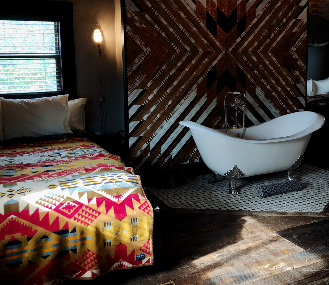 Urban Cowboy Nashville Golden hour light peeking in on one of the beds in the room. We loved all of the iconic western decor details. 