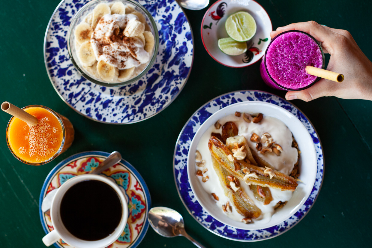 The Temple Lodge Colourful breakfast that will brighten up your day. The best breakfast in Bali! Coconut porridge and caramelised banana with muesli, local coffee and colourful jackfruit and mango juices. 