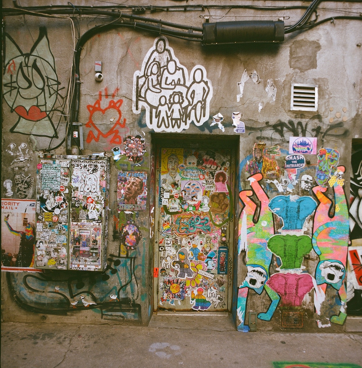 Sister City Plus the alley has some great street art plastered all over, this being the view directly across the entrance. Always take the alternate routes, right?