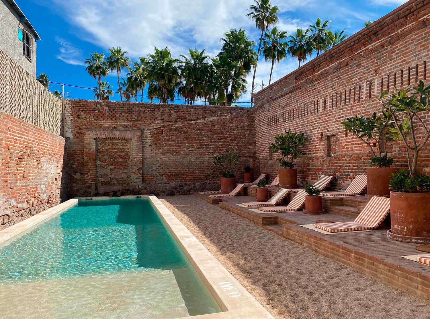 Baja Club The ruin-chic swimming pool area looks like an ancient Roman bath with a twist. 