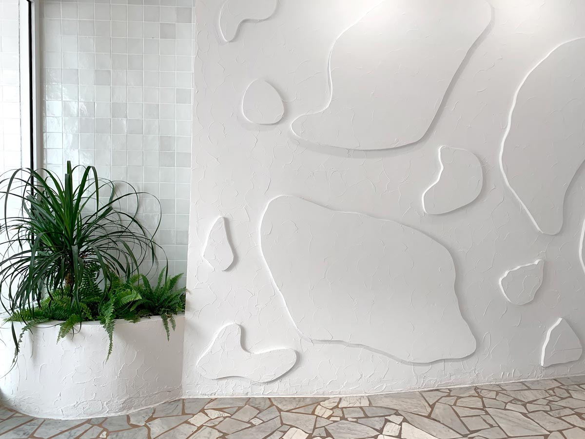 Hotel Le Sud Terrazzo floors meet hip sculpted walls in the hotel lobby