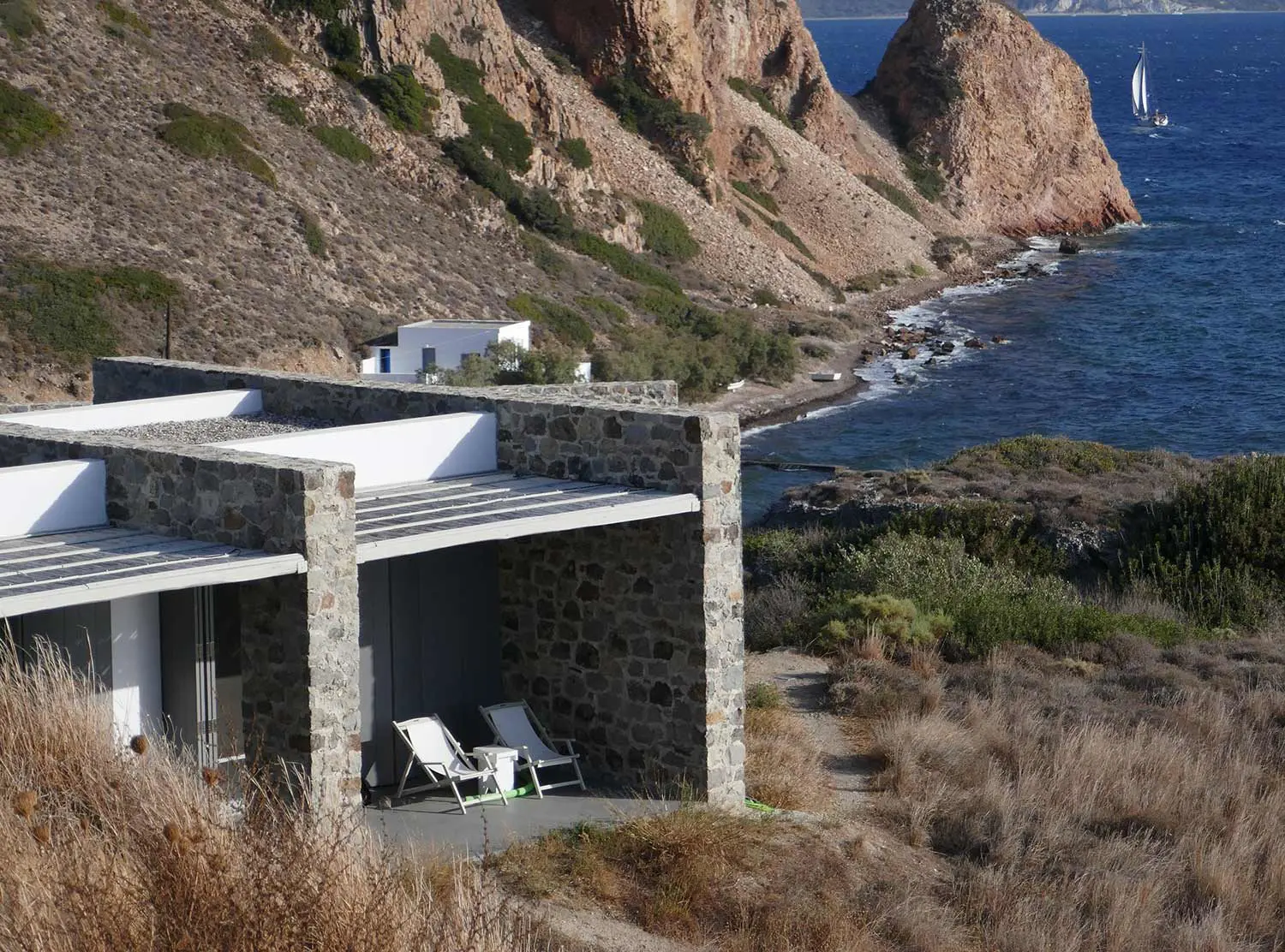 Skinopi Lodge We loved the minimal design elements and how the structure blends right into the cliffside