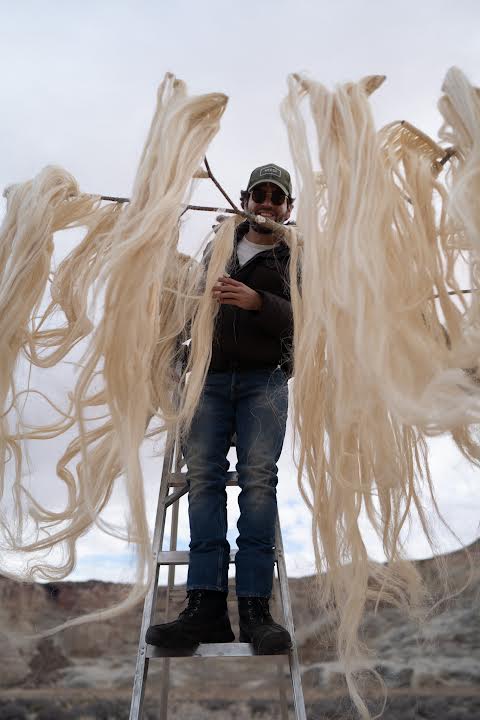 Tomás freezes for the hours long installation process in the Utah winter desert.