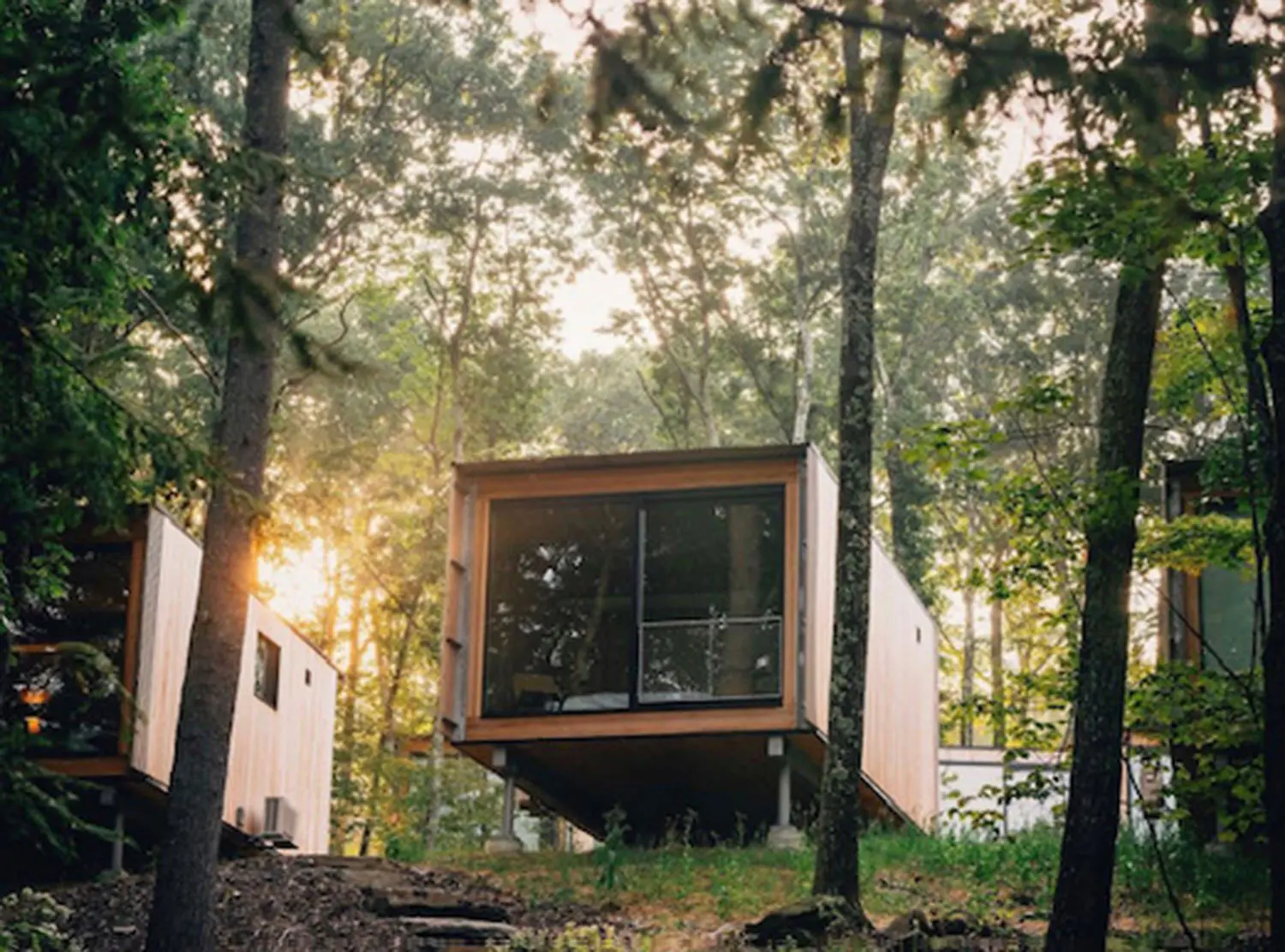 Piaule Each cabin sits on the edge of the land with their big windows facing the trees