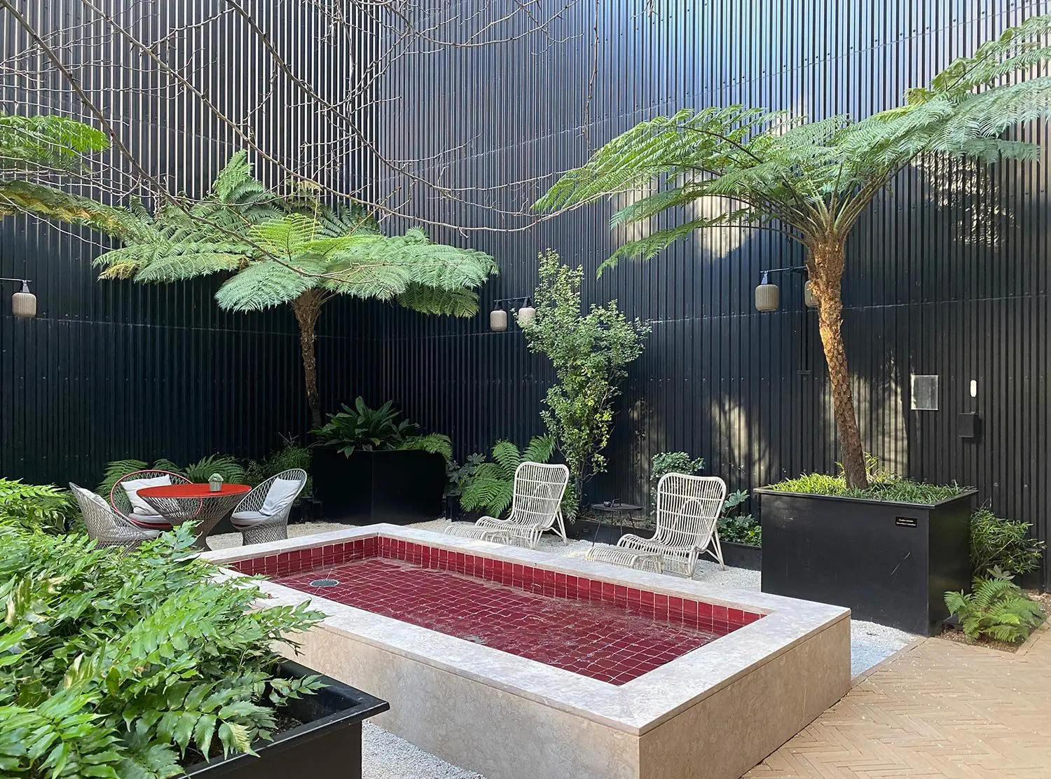 Valverde Hotel A peaceful corner at the patio. The red water feature marks the spot where the former swimming pool used to be