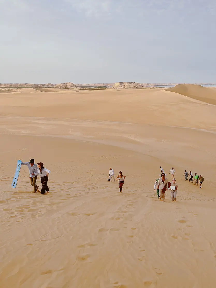 Adrere Amellal Eco-Lodge Attempting to sand board down the dunes